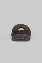 Black cap with a tree logo on a gray background
